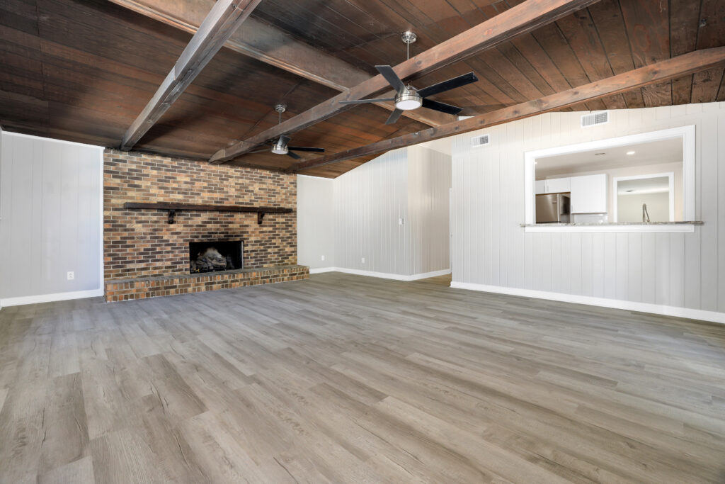 Renovated home, New gray paint, lvp floors, wood burning fireplace, brick, exposed brown beams, ceiling fans, listed by top realtor, John Wesley Brooks, Huntsville Al