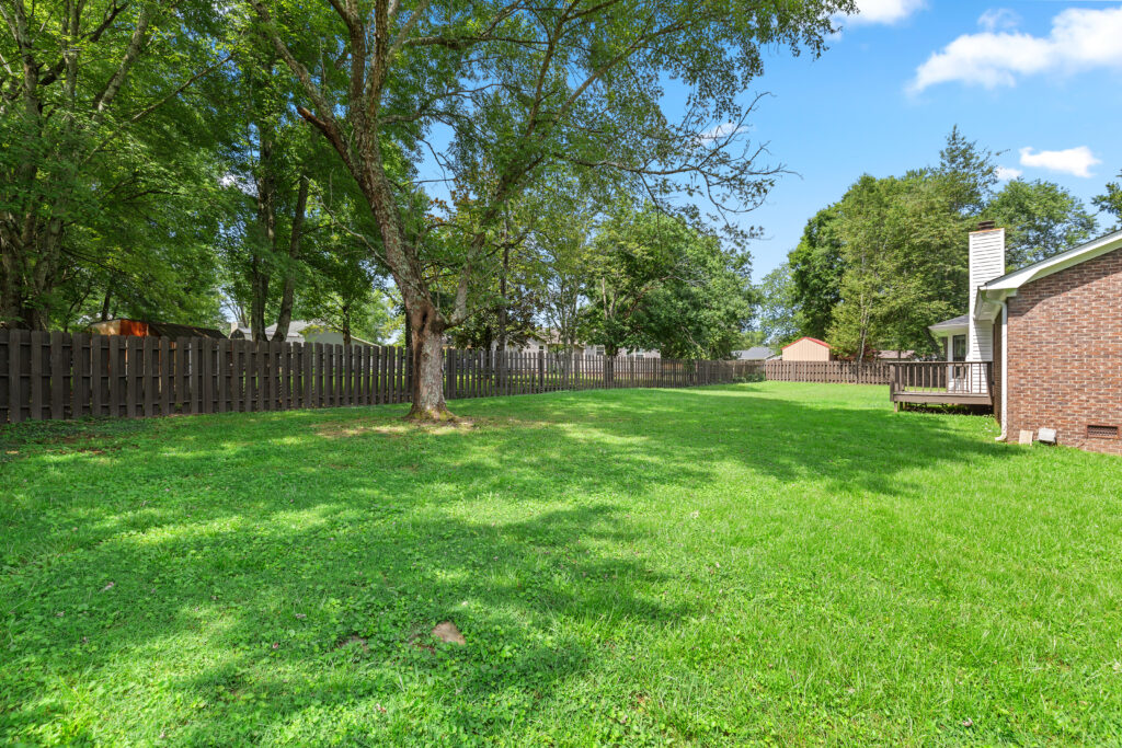 Backyard, new privacy fence, deck, brick home, move in ready renovated home in Hazel Green Alabama listed by John Wesley Brooks