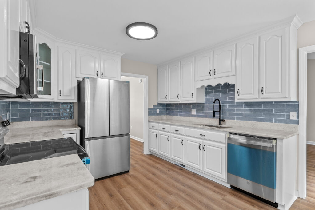 Kitchen, Stainless Steel appliances, new cabinets, white cabinets, lvp flooring, all new paint, property listed by John Wesley Brooks, Huntsville Alabama