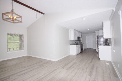 Renovated home for sale in huntsville Alabama, Gray walls, laminate flooring, upgraded lights and plumbing, tall vaulted ceilings, listed by top huntsville Realtor John Wesley Brooks