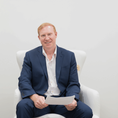Huntsville Alabama, Top Realtor, John Wesley Brooks, White chair, Blue suit, Alabama Top Realtor