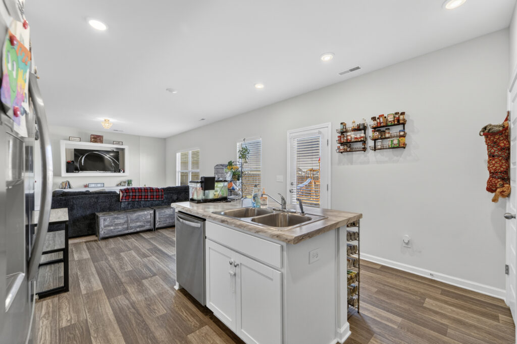 Affordable 3 bedroom home for sale in New Market AL, Kitchen view, gray walls, lvp flooring, move in ready home, listed by Huntsville best Realtor, John Wesley Brooks