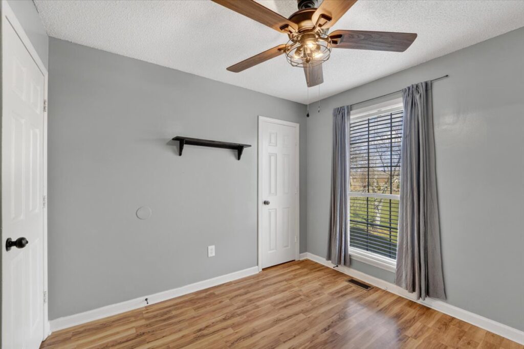 Bedroom, wood floor, gray walls, ceiling fan, white ceiling, modern updates, home for sale in Madison alabama, Top Realtor John Wesley Brooks