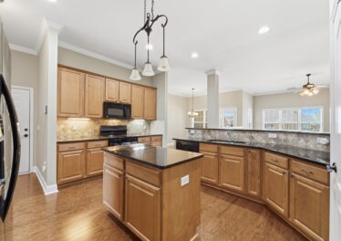 Kitchen with island, granite, hardwood floors, open floor plan, home for sale in Meridianville Alabama, Listed by the best Huntsville alabama Realtor John Wesley Brooks
