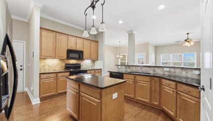 Kitchen with island, granite, hardwood floors, open floor plan, home for sale in Meridianville Alabama, Listed by the best Huntsville alabama Realtor John Wesley Brooks
