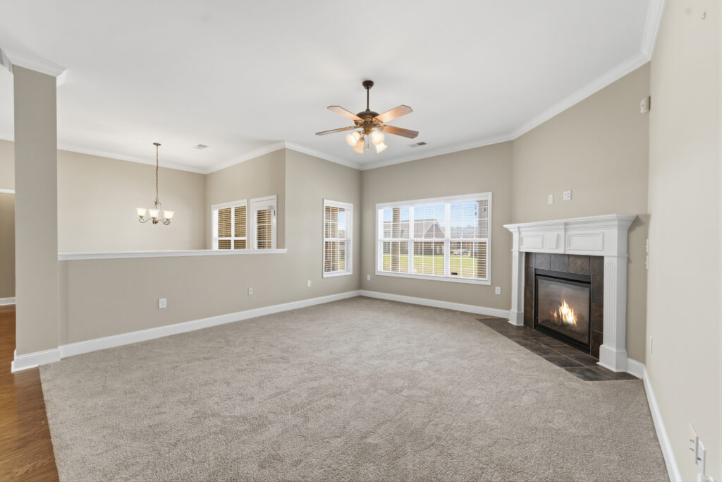 Family Room view, Fireplace, Open Floor Plan, Crown Molding, Carpet, Ceiling fan, smooth ceiling, new paint on wall, listed by John Wesley Brooks, The best realtor in huntsville