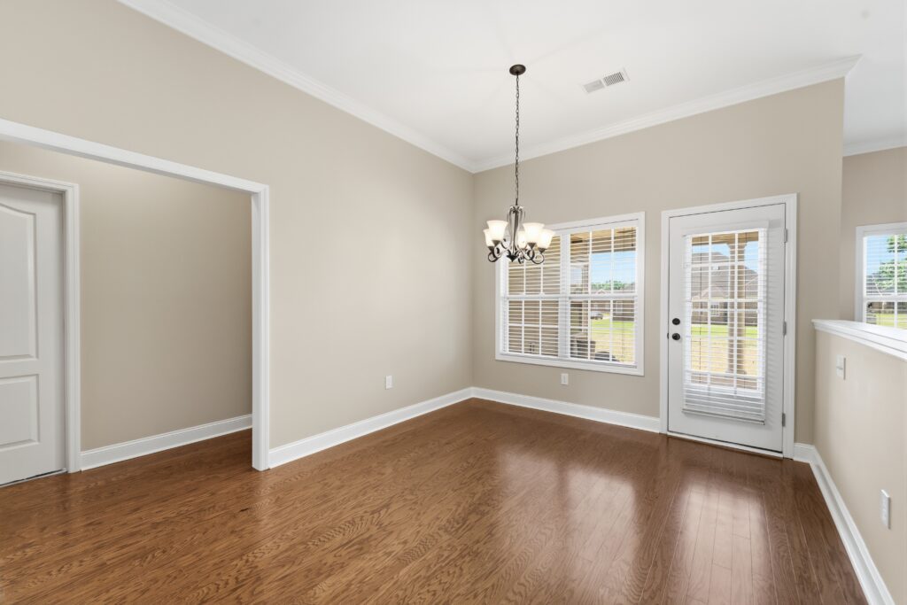 Dining room, wood floors, crown molding, new paint, door to access backyard, Meridianville Semi Custom Home listed by John Wesley Brooks The Best Huntsville Realtor