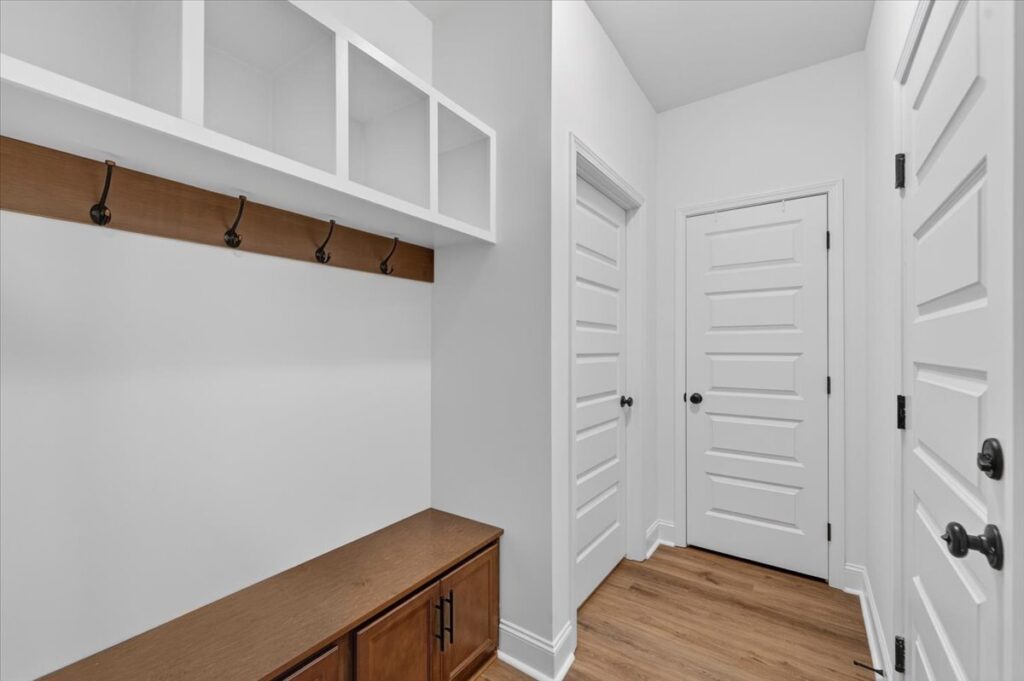 Upgraded open floor plan, drop zone, white and brown modern cabinets, LVP flooring, built ins, LVP flooring, home for sale in Harvest Alabama by the Best Madison Alabama Realtor John Wesley Brooks
