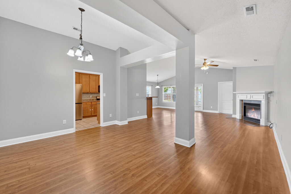 Family Room view, dinning room, open floor plan, fireplace, tall smooth ceilings, wood floors, grey modern wall color, Madison Alabama home for sale, 188 Amsterdam Place