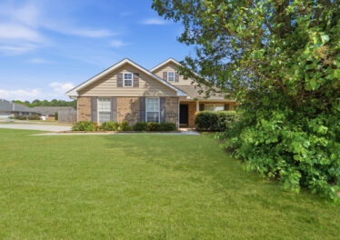 Full brick home in Madison Alabama, Front yard, green grass, blue skies