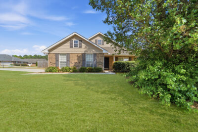 Full brick home in Madison Alabama, Front yard, green grass, blue skies