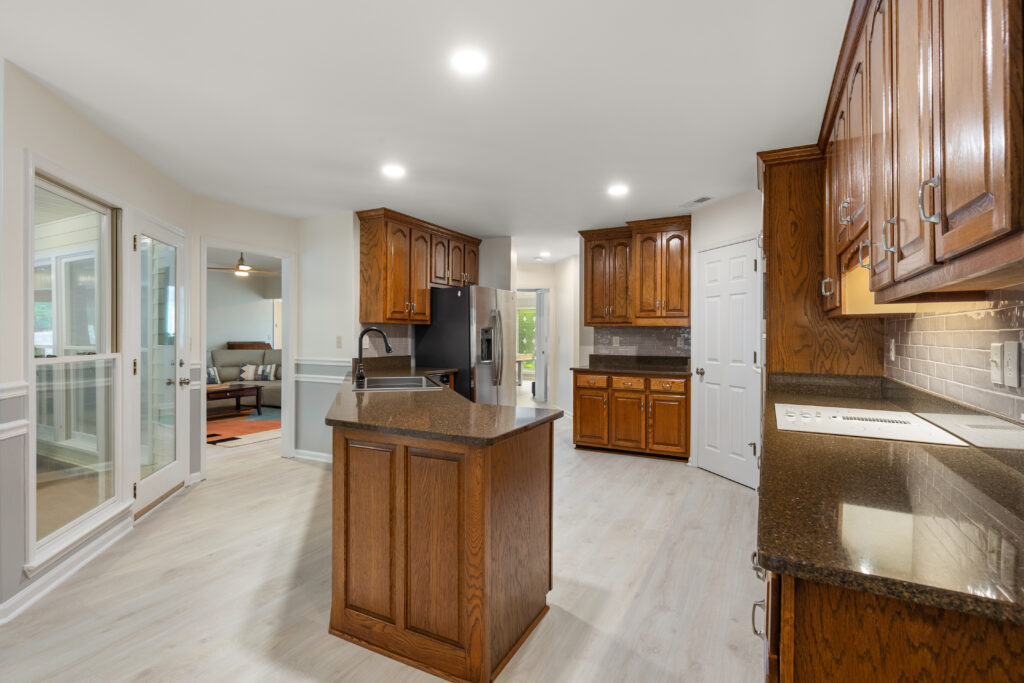Kitchen view from dining room area, updated home for sale, Modern mid century living, View to sunroom, family room, renovated home for sale in old big cove, hampton cove alabama home for sale, Best Huntsville Realtor John Wesley Brooks 