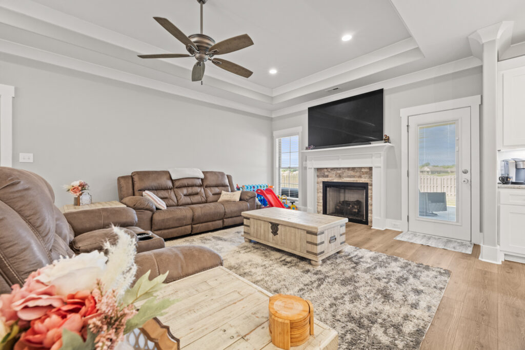 Family room, wood floors, tall smooth ceiling, fire place, Toney Alabama home for sale