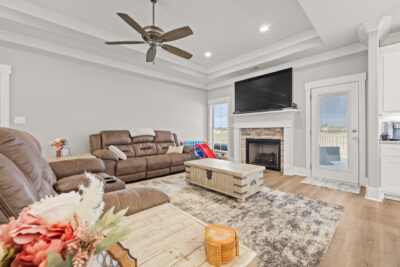 Family room, wood floors, tall smooth ceiling, fire place, Toney Alabama home for sale