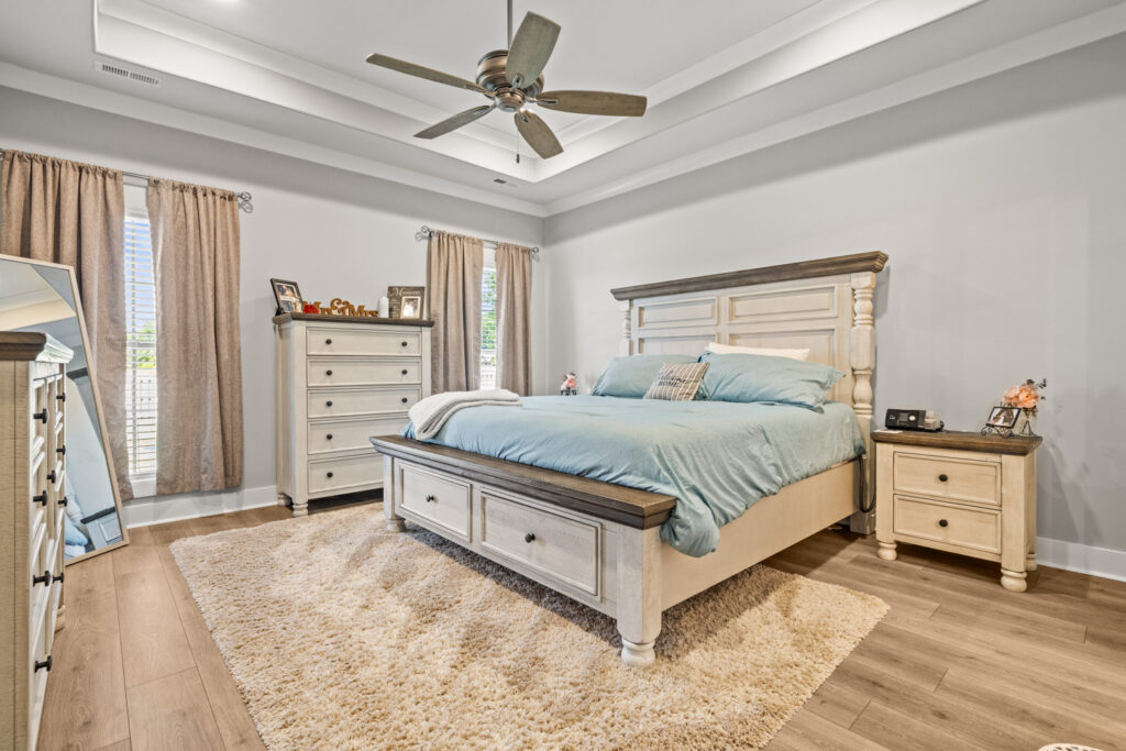 Master bedroom, spacious room, wood floors, tray ceiling, ceiling fan, home for sale in Toney Alabama