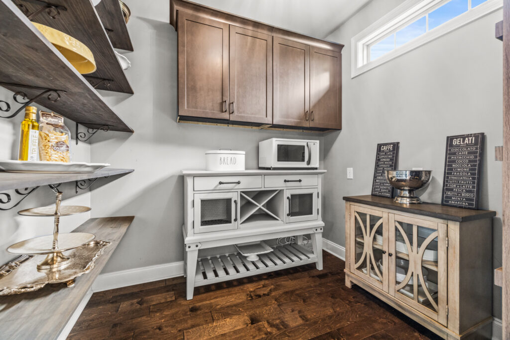 Butlers Pantry, Cabinets, Wood Floor, sliding pocket door, shelving, upgraded light, Listed by John Wesley Brooks, Custom home, Meridianville Alabama 