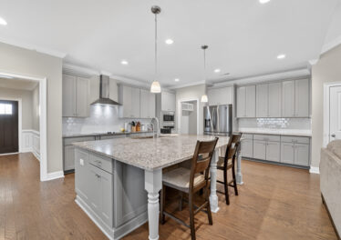 Upgraded move in ready home for sale in Meridianville Alabama, Modern Kitchen design, kitchen island, grey cabinets, stainless steel appliances, Home listed by Huntsville's best realtor John Wesley Brooks