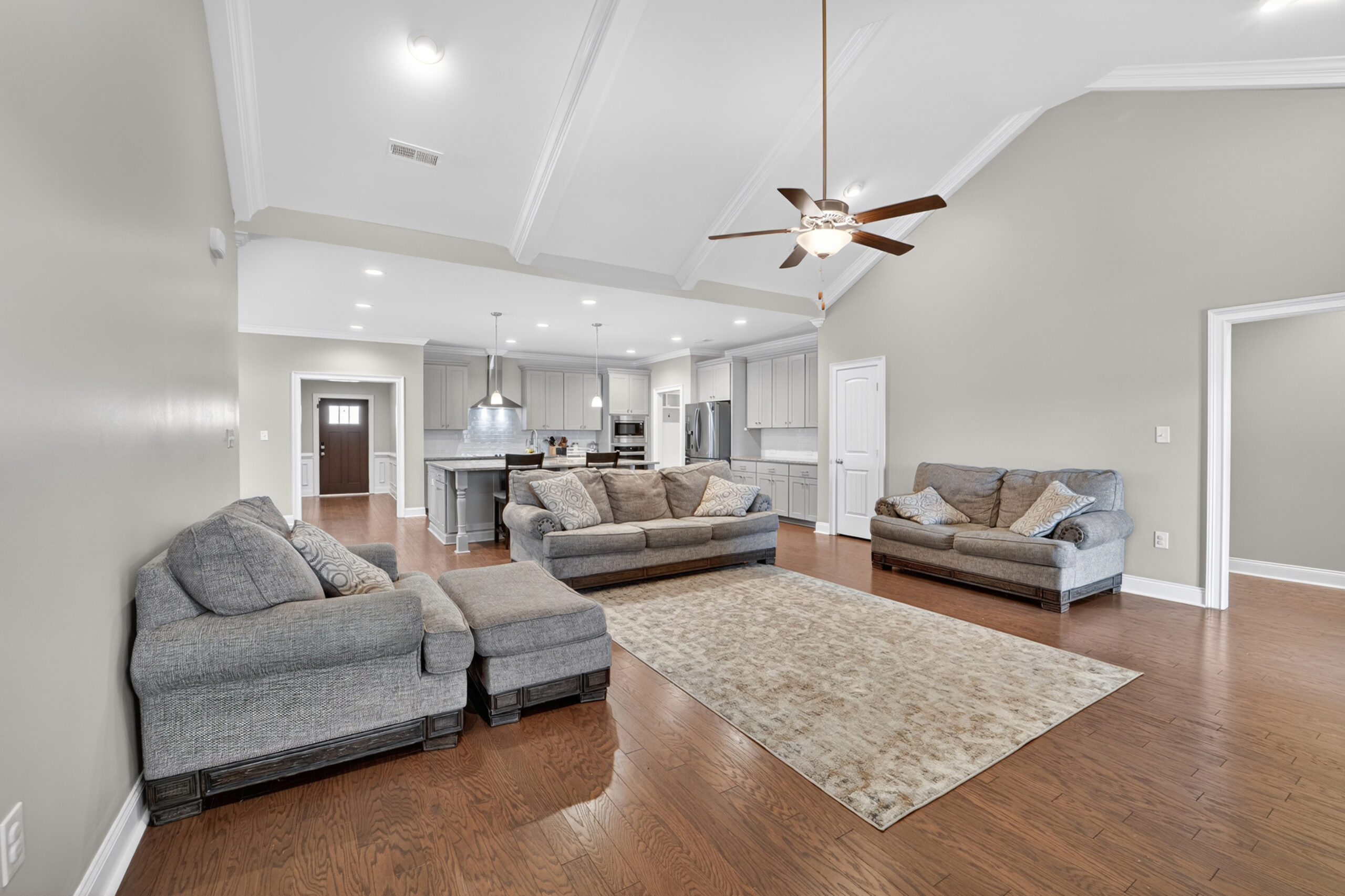 Family room view, open floor plan, wood floors, tall smooth ceilings, grey walls, living room view, John Wesley Brooks Top Realtor in Huntsville Alabama