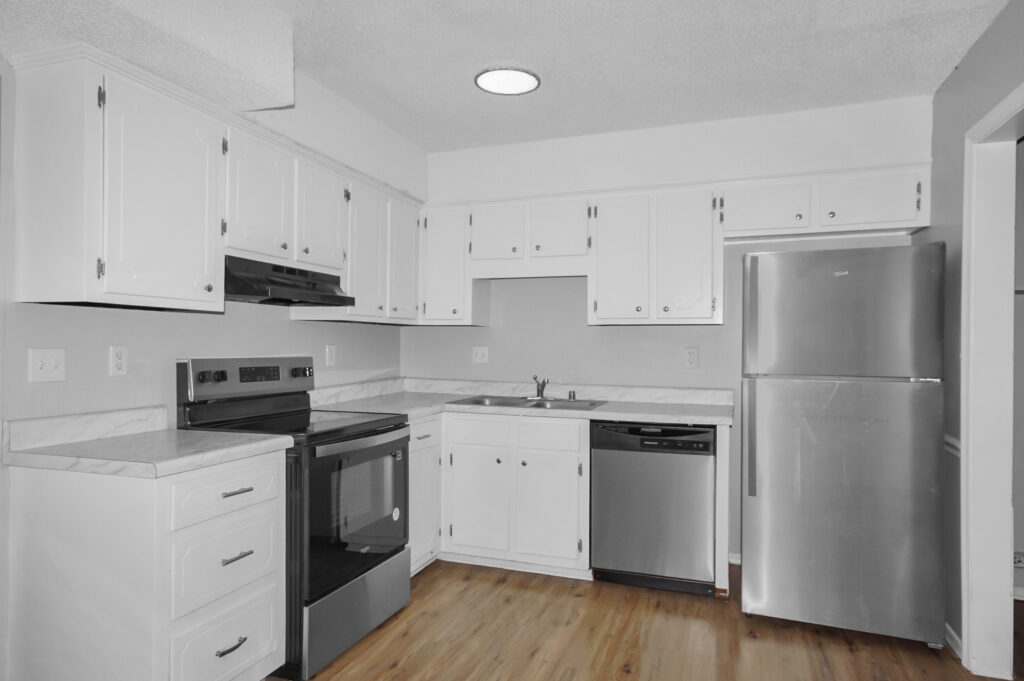 Kitchen, renovated kitchen, stainless steel appliances, wood floors, white cabinets, quad for sale in Huntsville Alabama by the best Realtor in huntsville, John Wesley Brooks