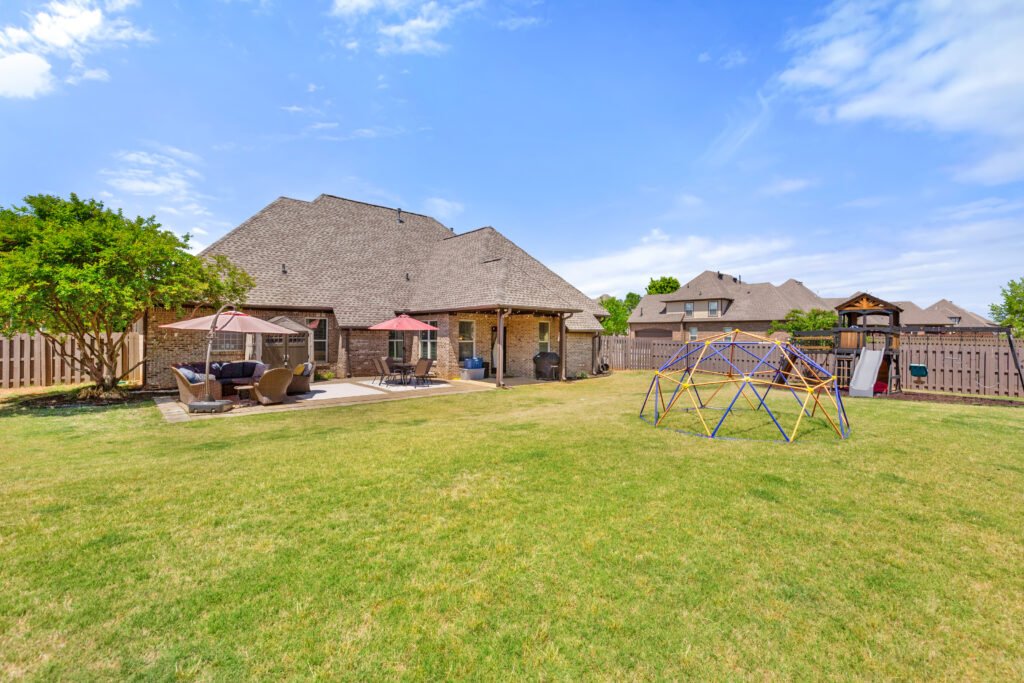 Backyard view, upgraded yard, green grass, full brick home, house for sale in Huntsville Alabama. 