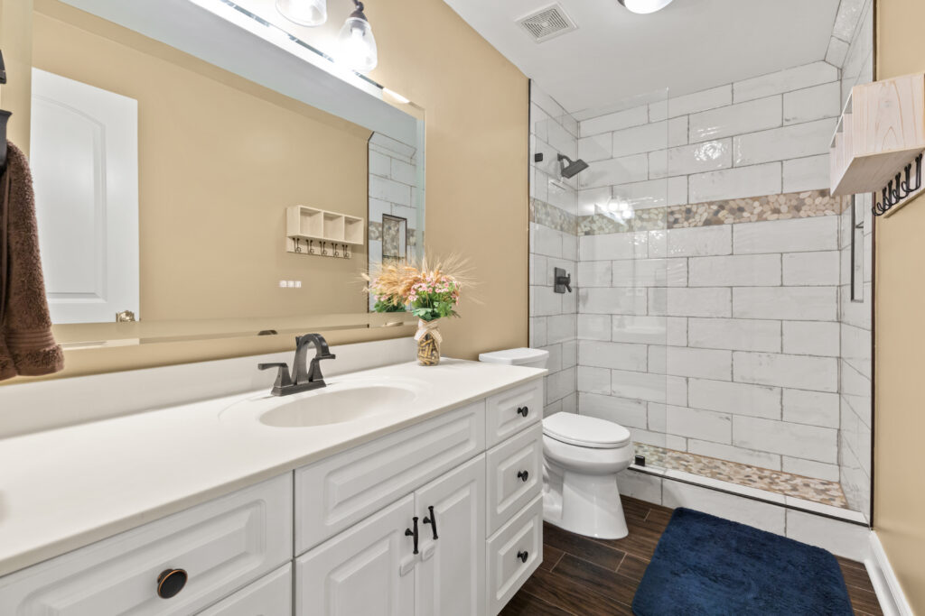 Bathroom, renovated home, white cabinets, white tile, house for sale