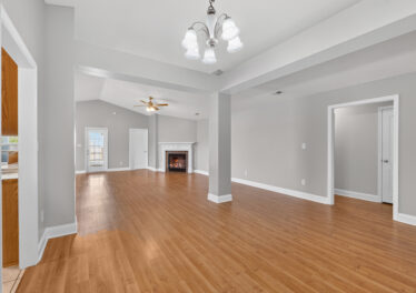 Madison home for sale, renovated, wood floors, grey walls, updated light fixtures, fireplace, large living room, listed by john Wesley Brooks